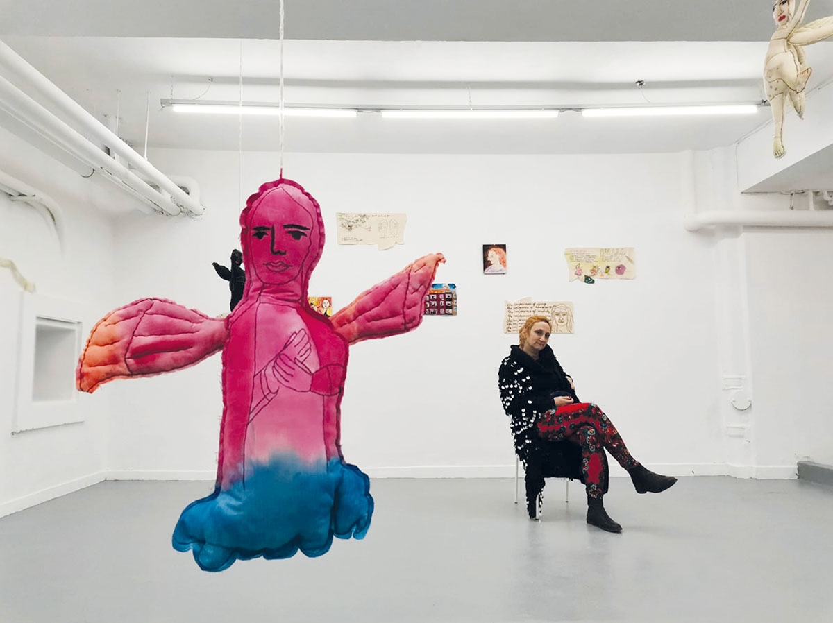 Raluca Ilaria Demetrescu sitting inside her installation area at MNȚRplusC