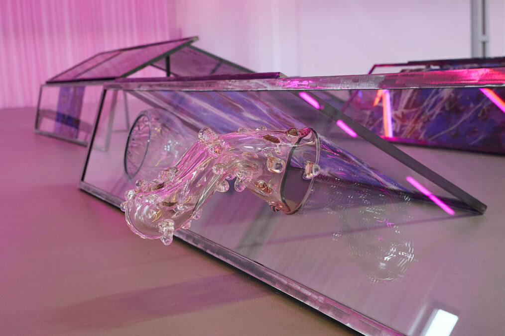 Euridice Zaituna Kala, Eutrophê: the wave (detail), 2025, iridescent metal frames, transfers on glass and metal, writing, engravings, seeds, glass. installation view Kunsthalle Münster 2026. Courtesy of the artist and galerie anne barrault. Photo: Moritz Hagedorn.