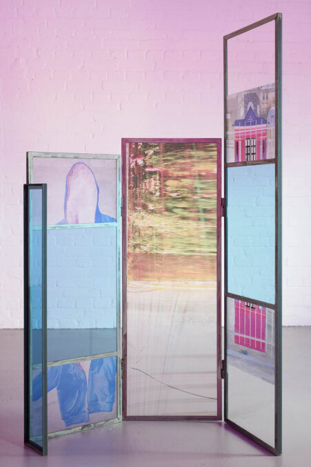 Euridice Zaituna Kala, Eutrophê: the wave (detail), 2025, iridescent metal frames, transfers on glass and metal, writing, engravings, seeds, glass. installation view Kunsthalle Münster 2026. Courtesy of the artist and galerie anne barrault. Photo: Moritz Hagedorn.
