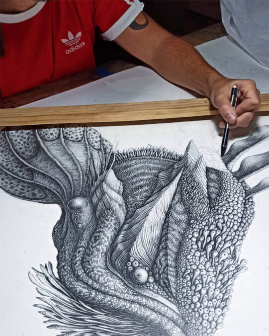 Guillem Font drawing on paper one of his creatures