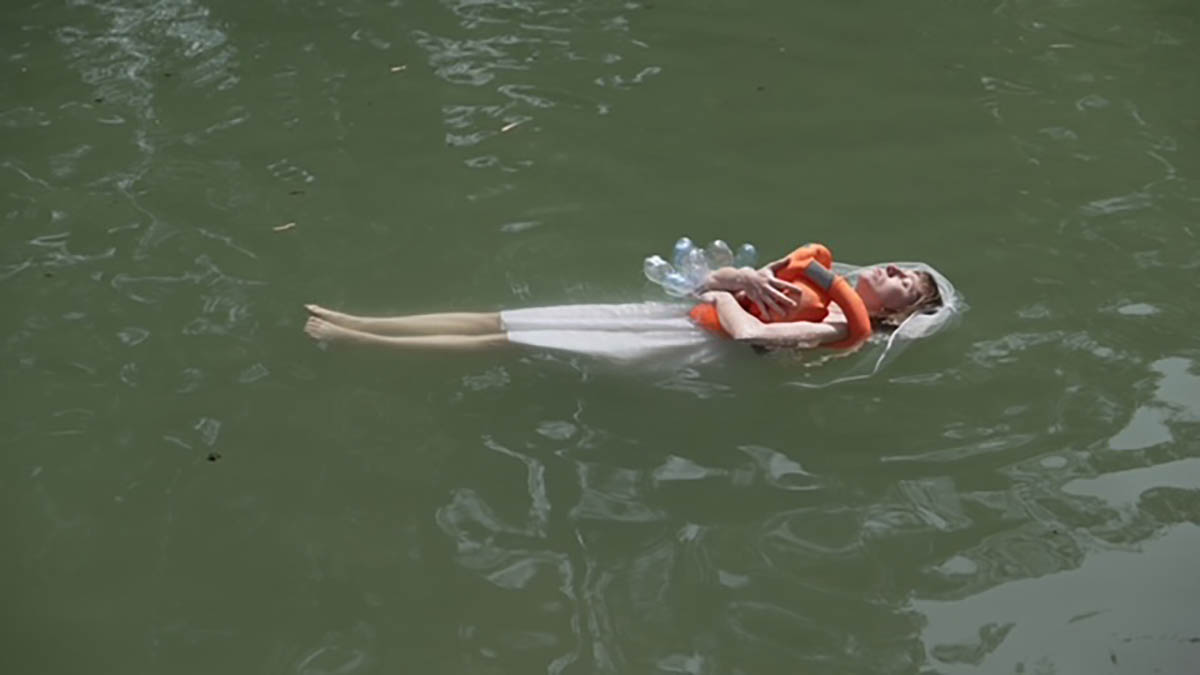 “My Savior, Yardenit”- video taken in the Jordan River, a personal life jacket, white dress, veil, plastic bottles (Photo: Matan Meirson)