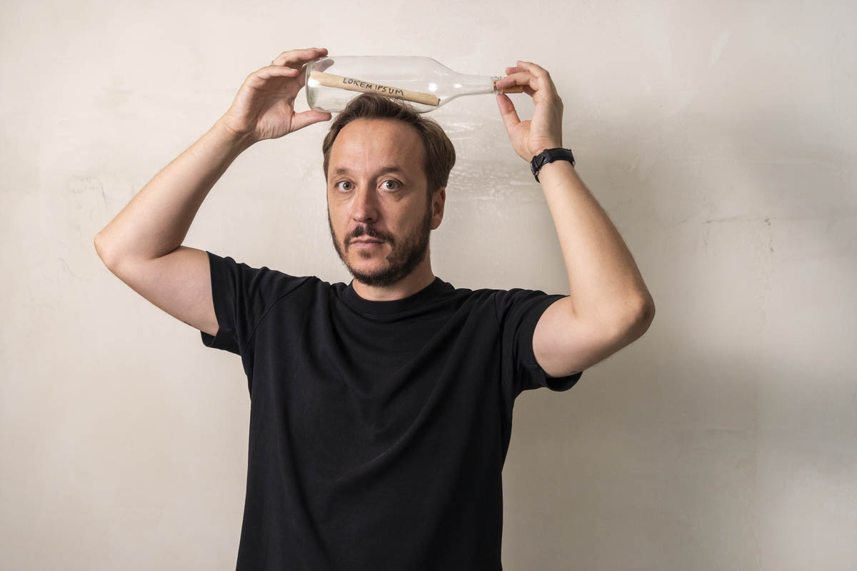 Driton Selmani — Lorem Ipsum, 2019 Carchoal pen on old school paper, found glass bottle Dimensions: 32 x 10 cm Ph: Ferdi Limani © Driton Selmani