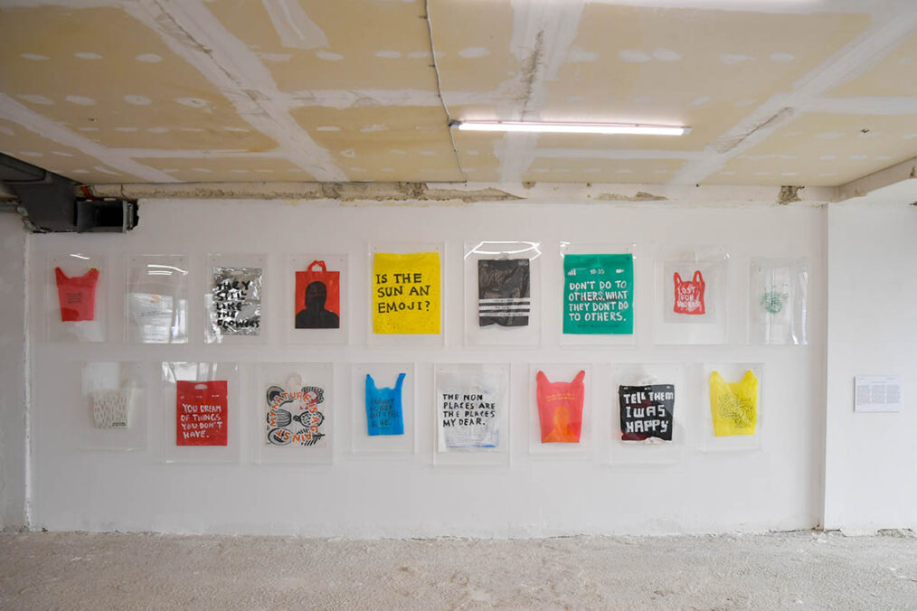 Driton Selmani — I Was Raised to Belong Everywhere but Fit Nowhere, I Speak a Language That Cancels Itself Mid-Sentence, I Own Documents That Prove Nothing, I Wear Pride Like a Border, and Smile Politely While Being Erased, 2025 Diptych, Black and white acrylic paint on found plastic bags 54 × 43 cm (objects), 75 × 65 × 5cm (frame) Ph: Ferdi Limani © Driton Selmani