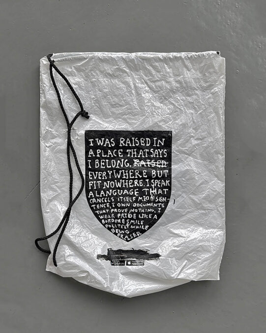 Driton Selmani — I Was Raised to Belong Everywhere but Fit Nowhere, I Speak a Language That Cancels Itself Mid-Sentence, I Own Documents That Prove Nothing, I Wear Pride Like a Border, and Smile Politely While Being Erased, 2025 Diptych, Black and white acrylic paint on found plastic bags 54 × 43 cm (objects), 75 × 65 × 5cm (frame) Ph: Ferdi Limani © Driton Selmani
