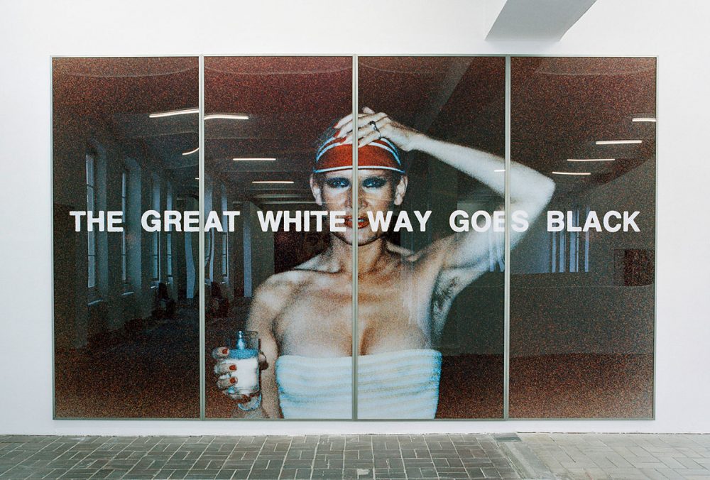 Katharina Sieverding, THE GREAT WHITE WAY GOES BLACK, IX, 1977. Color photograph, acrylic, and steel frames, 300 x 500 cm. Installation view of the exhibition: Katharina Sieverding – Close Up, KW Institute for Contemporary Art Berlin, 2005 © Katharina Sieverding, VG Bild-Kunst, Bonn 2021.