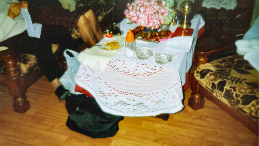 Photo Album, 2022, clamps, lamp, found photographs, magic arms, photo album, plywood, tripods, dimensions variable