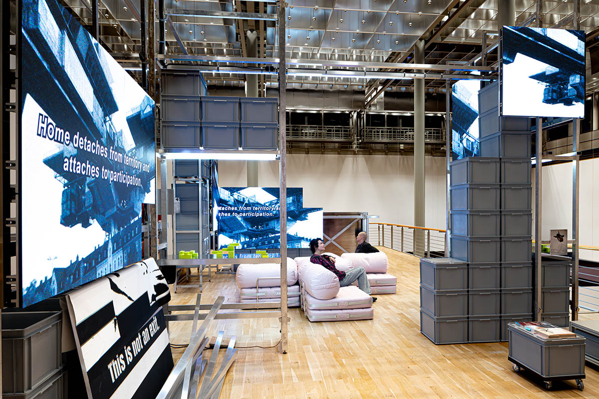 Exhibition view Tell Me Where Home Is Kunstmuseum Wolfsburg September 19, 2026–January 17, 2027 0001 After Money, Before God., 2026 Mixed-media installation with multichannel video, color, sound Dimensions variable, infinite duration Courtesy the artists photo: Marek Kruszewski