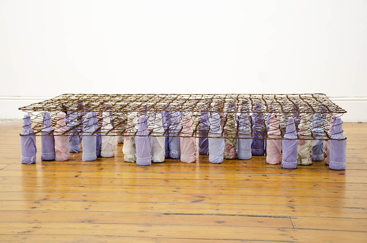 Lungiswa Gqunta - Let me ease the pain - bed spring, beer bottles, bed linen, string - 2016 - 30x190x90 cm.